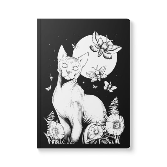 Notebook with a black and white illustration of a cat, butterflies, and flowers on a black background